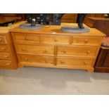 A modern pine bedroom chest of seven drawers