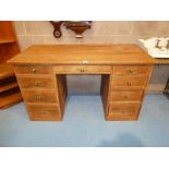A pine top double pedestal kneehole desk with oak drawer fronts
