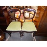 A pair of Victorian balloon back chairs