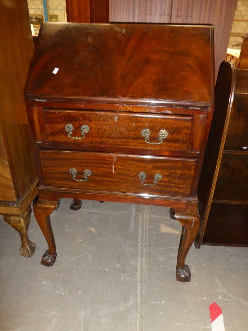 A reproduction mahogany fall front writing bureau on cabriole legs, claw and ball feet