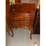 A reproduction mahogany fall front writing bureau on cabriole legs, claw and ball feet
