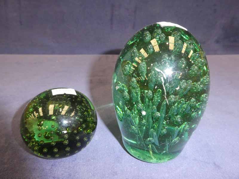 A Victorian green glass dump with bubble inclusions and a similar paper weight