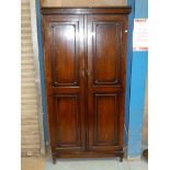 A 1930's oak single wardrobe with twin doors