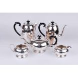 An early to mid-twentieth century silver plated tea set comprising tea pot, coffee pot, milk jug,