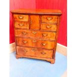 A George II walnut bachelors chest, the central pigeonhole cupboard is flanked by four small drawers