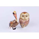 A Royal Crown Derby barn owl paperweight together with a further brown pelican example (2)