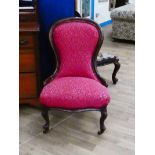 Victorian mahogany spoon back nursing chair on scroll legs and finished in claret brocade 88cm H