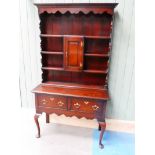 A George III oak dresser , the plate rack with central cupboard surmounts the two drawer base on