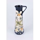 A Moorcroft small jug in the primrose pattern, impressed marks and purchase label to the base 18.5