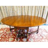 A handmade Titchmarsh & Goodwin drop leaf gateleg dining table