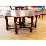 A good quality reproduction 18th century style oak wake table, hinged oval top with a pair of drop