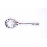 An Edward VII hallmarked silver shell shaped Serving Spoon with bust terminus and figural bowl