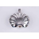 A silver scallop shell shaped perfume bottle with import markes to the neck and small silver funel