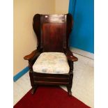 A late 19th Century stained fruitwood lambing chair on rockers, of dowel tennon construction and