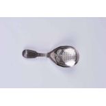 A Regency silver caddy spoon with brightcut decoration to the fiddle pattern handle and teardrop