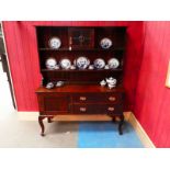 An oak Craft Dresser, the shallow rectangular moulded cornice above a shelved boarded display back