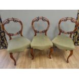 3 Victorian walnut open backed balloon chairs with stylised acanthus leaf decoration over stuffed