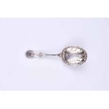 A late Victorian silver caddy spoon with anthemion pattern handle and repousse plumes to the bowl,