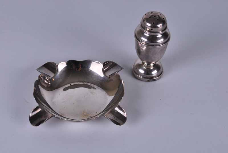 A George V silver bun pepperpot, Birmingham 1933 by Marson & Jones, on loaded base; together with