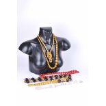 A dark cherry amber style and metal bead necklace 64 cm L, a cinnabar lacquer necklace 67 cm L,