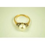 An 18 ct gold Hong Kong cultured 8 mm pearl solitaire ring with chip diamond set shoulders P 1/2 3.