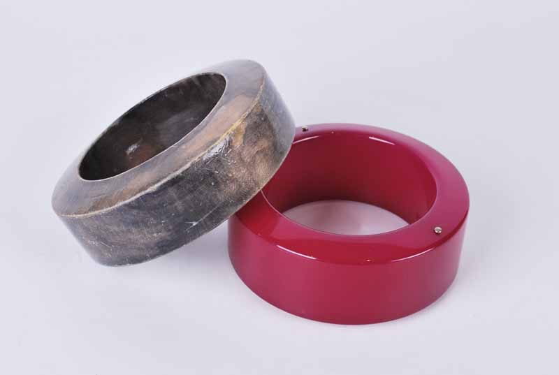 Pair Lanvin y Paris bangles, one in magenta plastic, the other finished wood