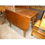 A mid century mahogany drop leaf dining table