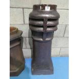 A glazed terracotta Chimney pot with integral vent