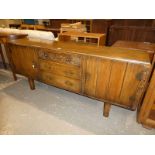 An oak long John style sideboard with carved detail.
