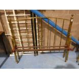A brass double bedstead with rails.