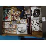 A large tray of mixed costume jewellery.