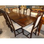 An old charm oak extending draw leaf refectory table and a set of eight dining chairs with