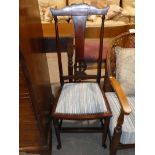 An Edwardian mahogany bedroom chair.