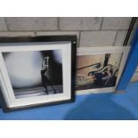 A framed print of a dancer and an unframed print of a lady recumbent.