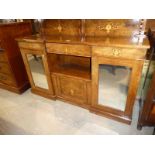 An Edwardian inlaid mahogany chiffonier with a pair of mirrored doors and low back shelf.