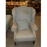 George III stained beech framed winged armchair.