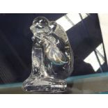 A Baccarat clear glass paperweight modelled as a kneeling female nude