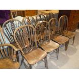 A set of eight hooped wheel back Windsor style ash and elm dining chairs.