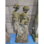 A stonecraft Garden sculpture featuring a peasant boy and a girl