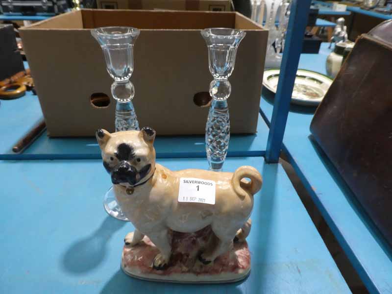 Pair of lead crystal candlesticks and a pottery staffordshire style pug dog.