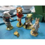 Four Beswick pottery models: Pig Prom, Last Lion, Fly Fishing and Peter Rabbit gardening.