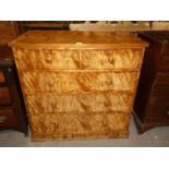 A Victorian quilted mahogany bedroom chest of two over three drawers.