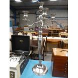 A large white metal four branch candle stand.