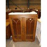 An art deco oak 2 door glazed display cabinet.