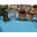 A Beswick copper lustre Tankard, A Doulton jug and beaker in part treacle glaze, and an early