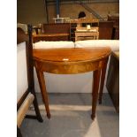 A reproduction mahogany effect demi lune hall table.