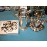 A selection of EPNS including a cocktail shaker, eggwaiter, napkin rings and eleven tea spoons