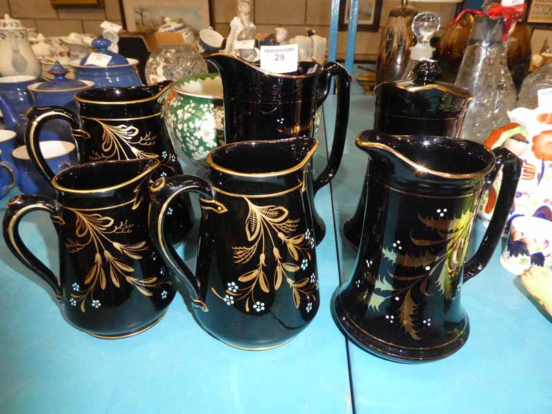 Six items of Jackfield pottery jugs