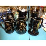 Six items of Jackfield pottery jugs
