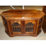 An oriental hardwood and metal fronted corner media stand